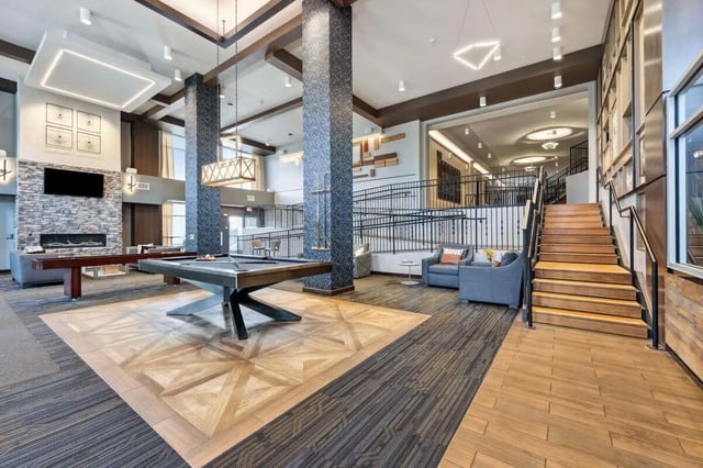 Pool tables fireplace sitting area stairs communal area at The Valley Apartments & Townhomes in State College Student Accommodation