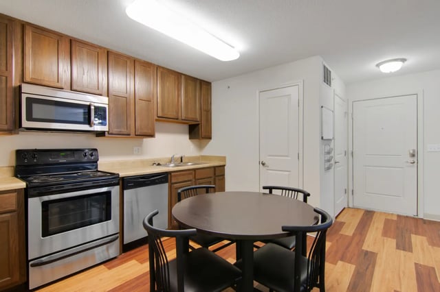 Kitchen with appliances dining table and chairs kitchen at The Jefferson Apartments in Springfield Student Accommodation