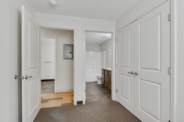 White doors open to study and bathroom Bathroom at The Jefferson Apartments in Springfield Student Accommodation