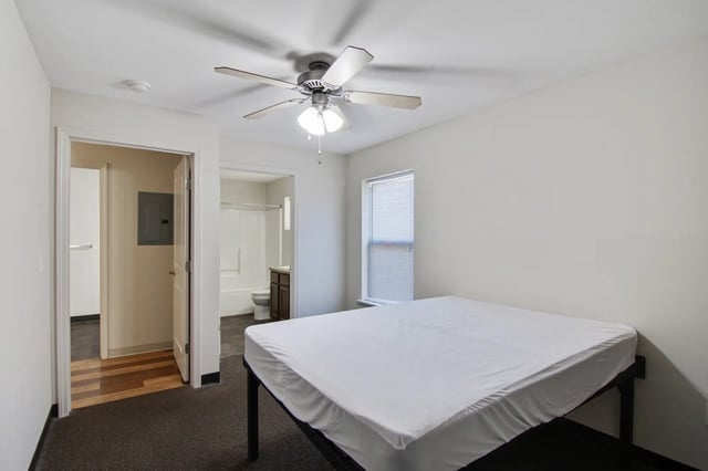 Bed ceiling fan window leads to bathroom bedroom at The Jefferson Apartments in Springfield Student Accommodation
