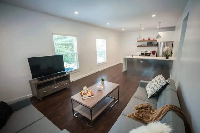Sofa TV coffee table kitchen living room at Campus Prime in Syracuse Student Accommodation