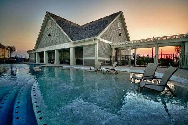 Pool chairs and building exterior at Campus Quarters in Corpus Christi Student Accommodation