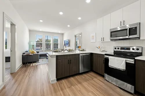 Modern kitchen with island and living area kitchen living room at The Jolly Roger in Greenville Student Accommodation