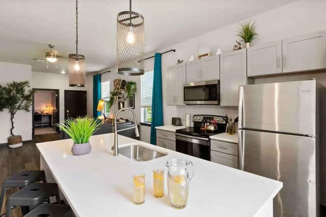 Modern kitchen with island and stainless steel appliances kitchen at Atlas on 17th in Bloomington Student Accommodation