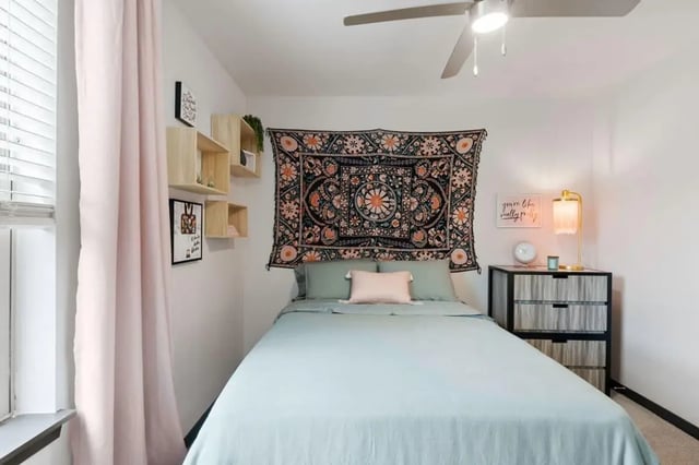 Bed tapestry shelves lamp nightstand bedroom at Atlas on 17th in Bloomington Student Accommodation