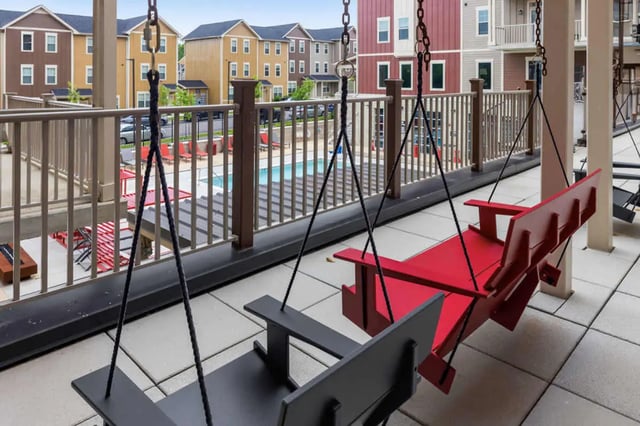 Swinging chairs pool and buildings exterior at Atlas on 17th in Bloomington Student Accommodation