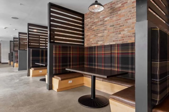 Booth seating with tartan cushions and tables study area at Atlas on 17th in Bloomington Student Accommodation