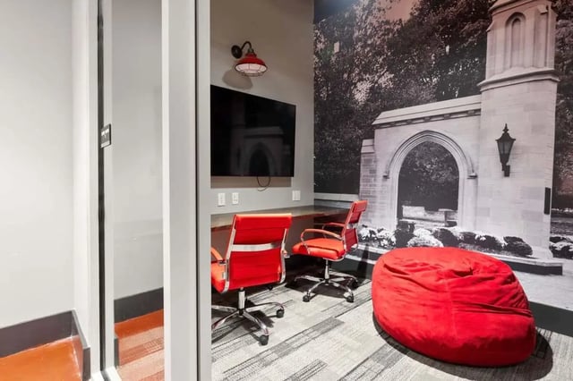 Two red chairs TV and beanbag study area at Atlas on 17th in Bloomington Student Accommodation