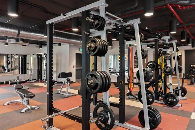 Weight racks barbells and benches gym area at Atlas on 17th in Bloomington Student Accommodation