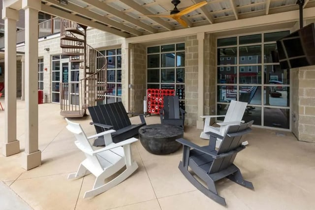 Outdoor seating area with chairs and table exterior at Atlas on 17th in Bloomington Student Accommodation