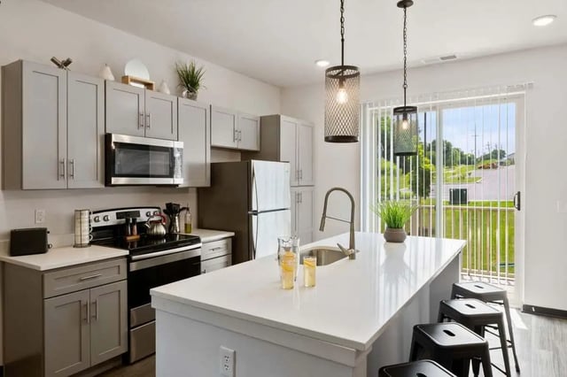Modern kitchen with island and stools kitchen at Atlas on 17th in Bloomington Student Accommodation