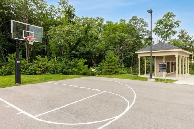 Basketball court with hoop and pavilion playing area at Atlas on 17th in Bloomington Student Accommodation