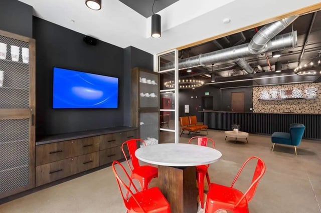 Table with red chairs and TV living room at Atlas on 17th in Bloomington Student Accommodation