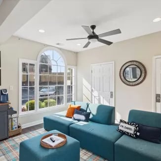Teal sofas ottoman coffee table living room at Eighteen18 at Southern in Statesboro Student Accommodation