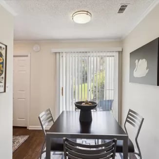 Dining table and chairs by sliding door dining area at Eighteen18 at Southern in Statesboro Student Accommodation