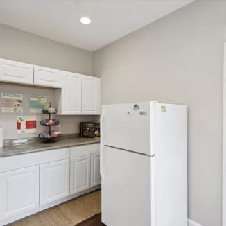 White cabinets refrigerator and counter kitchen at Eighteen18 at Southern in Statesboro Student Accommodation
