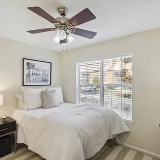 Bed with white bedding nightstand framed art bedroom at Eighteen18 at Southern in Statesboro Student Accommodation