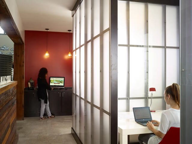 People using laptops at desks study area at The Junction at College Station in College Station Student Accommodation
