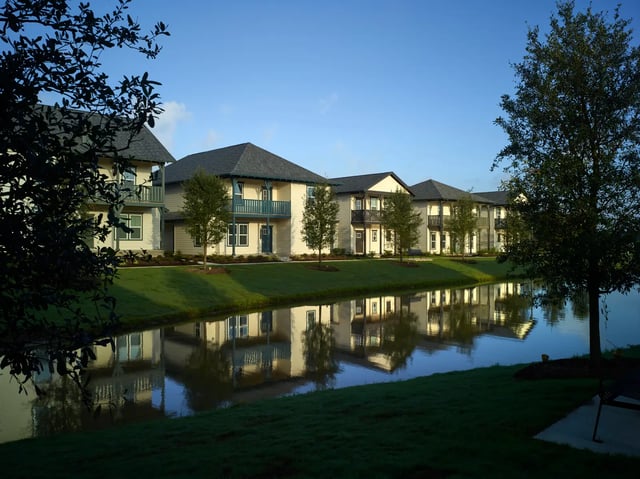 Apartment buildings with balconies reflect water exterior at The Junction at College Station in College Station Student Accommodation