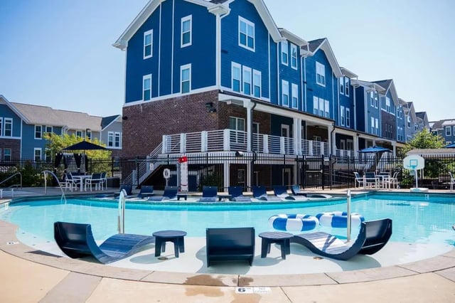 Blue apartment buildings pool lounge chairs exterior at The Dillon in Bloomington Student Accommodation
