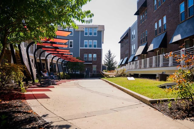 Outdoor seating area with hammock and buildings exterior at The Dillon in Bloomington Student Accommodation