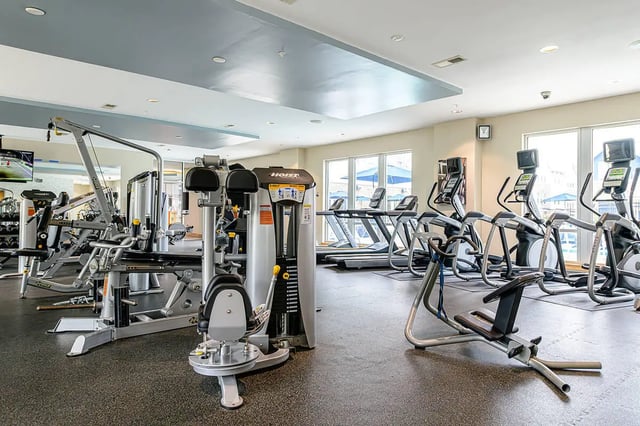 Gym equipment treadmills ellipticals and weight machines fitness area at The Dillon in Bloomington Student Accommodation