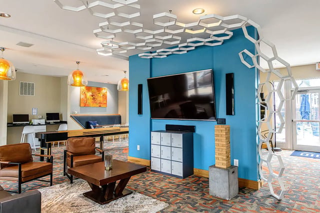 Leather chairs TV lockers and Jenga living area at The Dillon in Bloomington Student Accommodation