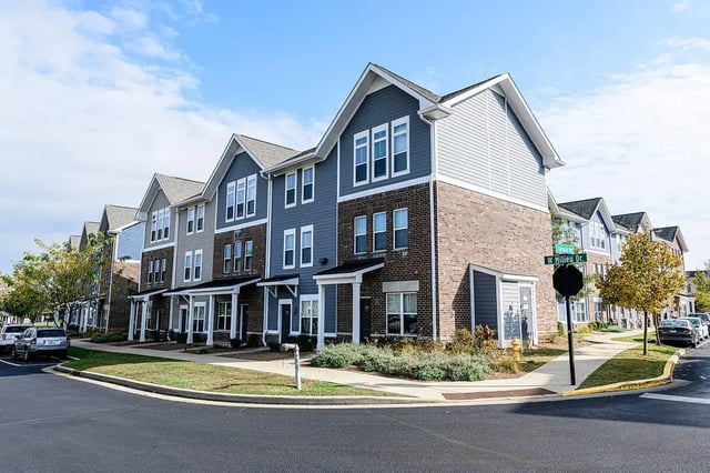 Townhouses with brick and siding exterior exterior at The Dillon in Bloomington Student Accommodation