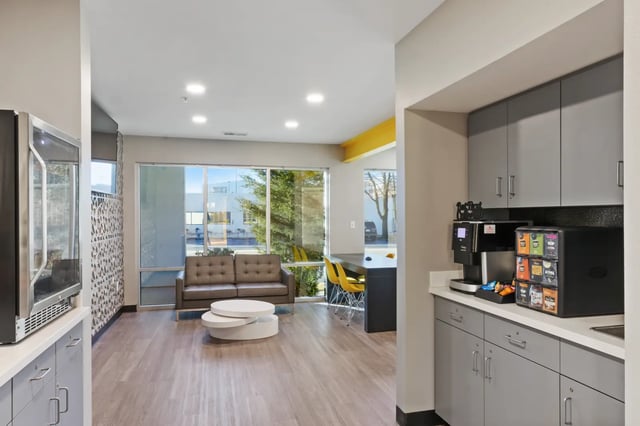 Sofa coffee table and kitchen area lounge at Deep Elm, Elevate Student Living in Springfield Student Accommodation