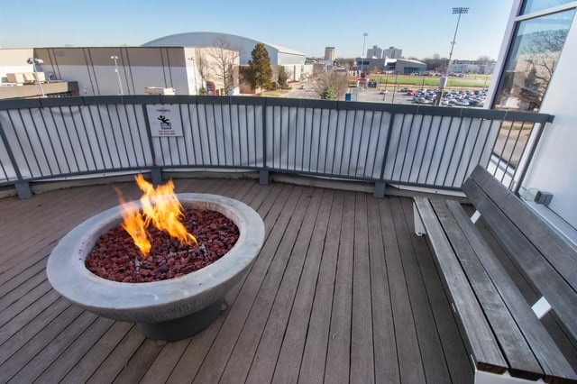 Fire pit and bench on deck balcony exterior at Deep Elm, Elevate Student Living in Springfield Student Accommodation