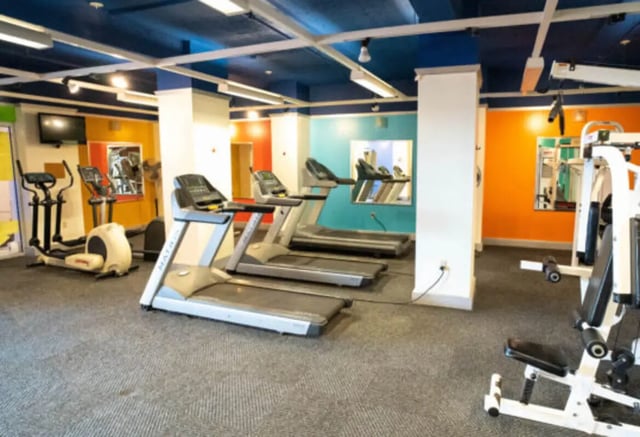 Treadmills ellipticals and weight machine gym at Century Towers Apartments in Kansas City Student Accommodation