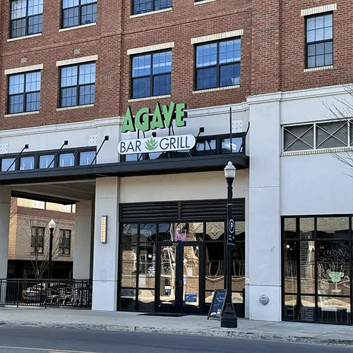 Brick building with Agave Bar Grill entrance exterior at Uncommon Auburn in Auburn Student Accommodation