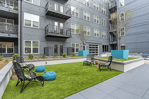 Chairs beanbags on grass courtyard exterior at Uncommon Auburn in Auburn Student Accommodation