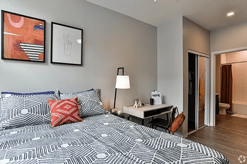 Bed desk lamp artwork and closet bedroom at Uncommon Auburn in Auburn Student Accommodation