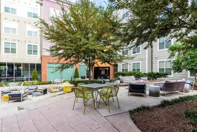 Outdoor patio with tables chairs and seating area exterior at The Boundary At West End in Greenville Student Accommodation
