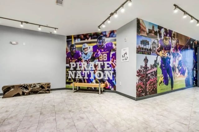 Wall mural with football players and bench area at The Boundary At West End in Greenville Student Accommodation