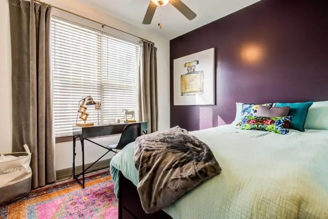 Bed desk laundry basket colorful rug bedroom at The Boundary At West End in Greenville Student Accommodation
