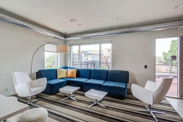 Blue sectional sofa white armchairs two tables living room at The Knoll Dinkytown in Minneapolis Student Accommodation