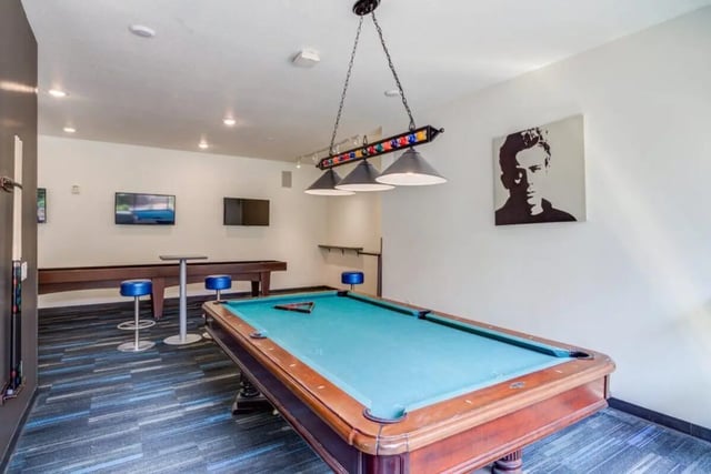 Pool table shuffleboard TVs and stools Recreation room at The Knoll Dinkytown in Minneapolis Student Accommodation