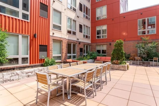 Dining tables and chairs on outdoor patio exterior at The Knoll Dinkytown in Minneapolis Student Accommodation