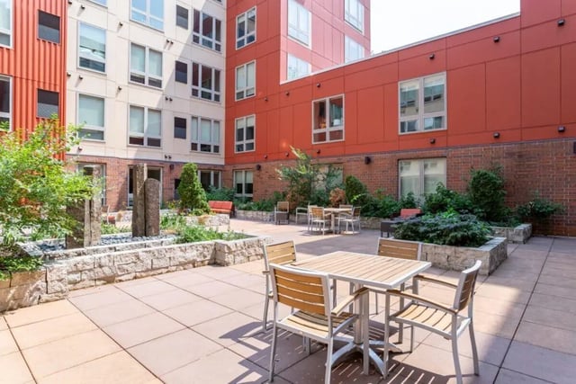 Patio seating with tables and chairs exterior at The Knoll Dinkytown in Minneapolis Student Accommodation
