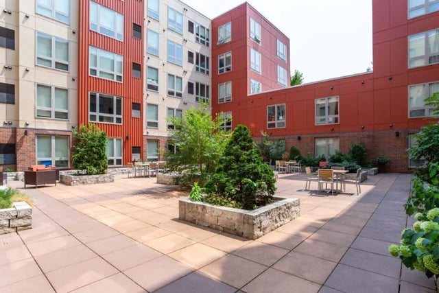 Courtyard with tables chairs and planters courtyard at The Knoll Dinkytown in Minneapolis Student Accommodation