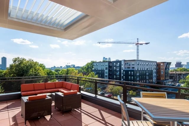 Rooftop patio with sectional sofa and tables exterior at The Knoll Dinkytown in Minneapolis Student Accommodation