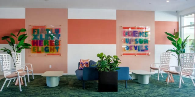 Modern lounge area with colorful art and seating Living room at Apollo Tempe in Tempe Student Accommodation
