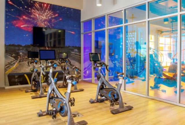 Spinning bikes and TVs with fireworks mural gym at Apollo Tempe in Tempe Student Accommodation