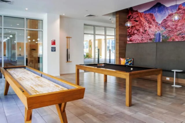 Shuffleboard and pool tables communal lounge at Apollo Tempe in Tempe Student Accommodation