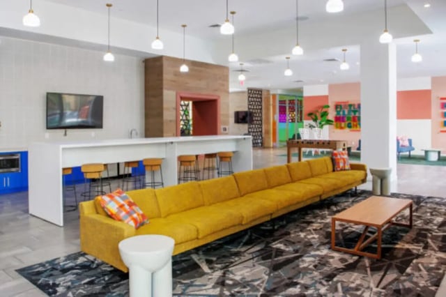 Sofa bar stools tv coffee table living room at Apollo Tempe in Tempe Student Accommodation