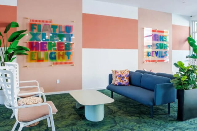 Colorful art chairs blue sofa coffee table living room at Apollo Tempe in Tempe Student Accommodation