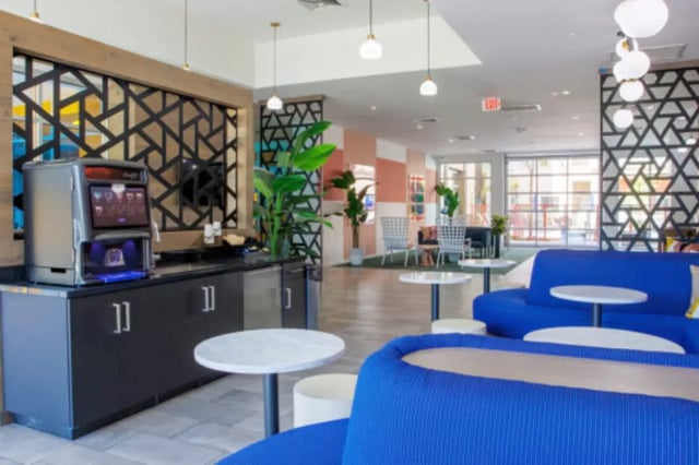 Coffee machine blue sofas white tables lounge area at Apollo Tempe in Tempe Student Accommodation