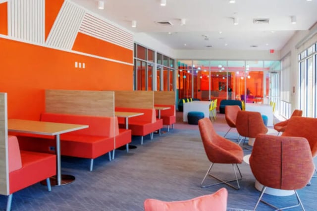 Orange booths and chairs communal area at Apollo Tempe in Tempe Student Accommodation